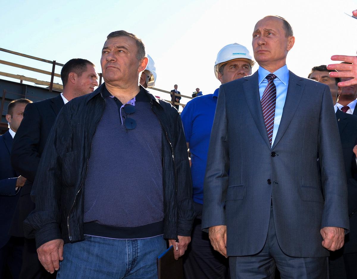 Russian President Vladimir Putin joins billionaire Arkady Rotenberg (left), during to a visit to the construction site of the Kerch Strait bridge in Kerch, Crimea. Investigators traced $18m in art purchases to shell companies linked to Rotenberg and his brother Boris, who are close Putin associates who American officials say benefited financially from the annexation of Crimea Alexei Druzhinin/Sputnik, Kremlin, File Pool Photo via AP