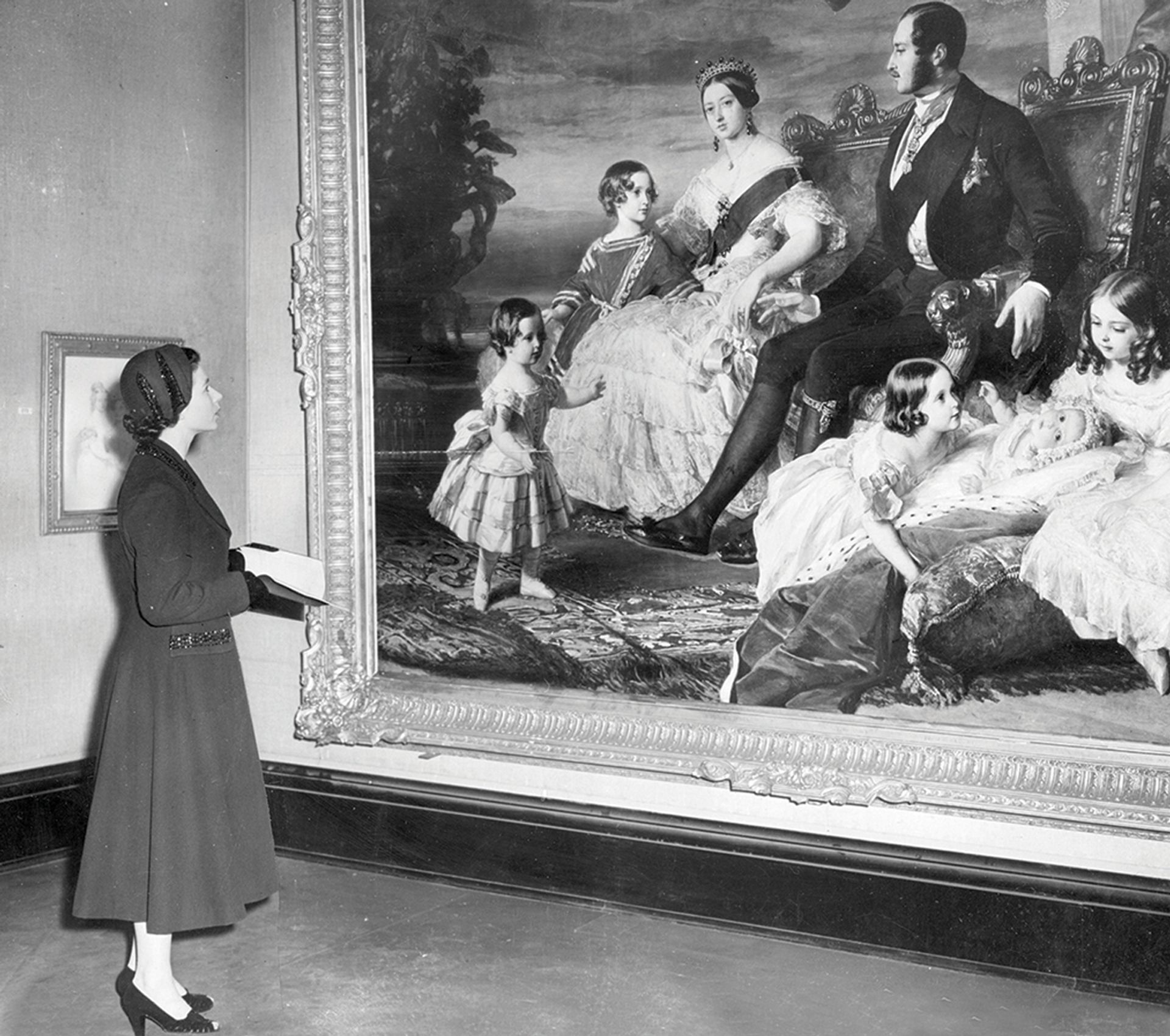 The Queen standing before Royal Family, by Franz Winterhalter, on loan to the Royal Academy's Kings and Queens AD653-1953 exhibition at Burlington House, London, 1953. Keystone/Getty Images