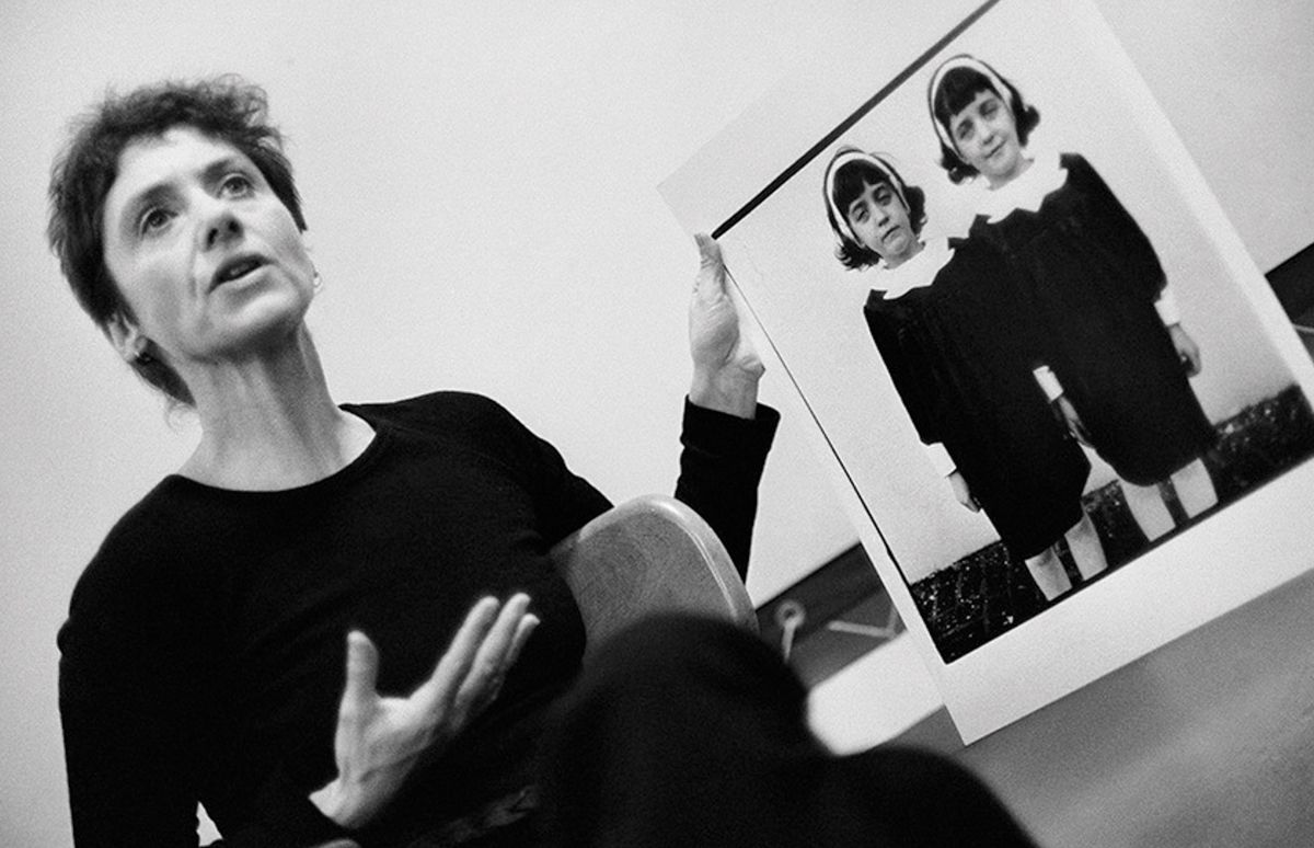 Photographer Diane Arbus, pictured here in 1970, holding up one of her most famous photographs, Identical Twins, Roselle, New Jersey (1966), during a lecture at the Rhode Island School of Design © Stephen A Frank.