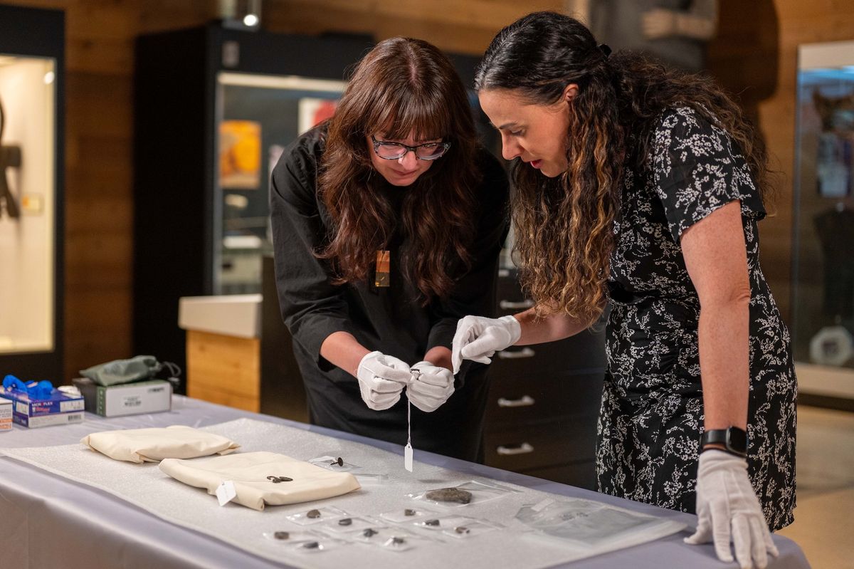 Sabrina Higgins (left), Simon Fraser University associate professor of global humanities and archaeology, and Barbara Hilden (right), director of the SFU Museum of Archaeology and Ethnology, examine the rare artefacts that have been donated to SFU for study Photo: Simon Fraser University/Sam Smith