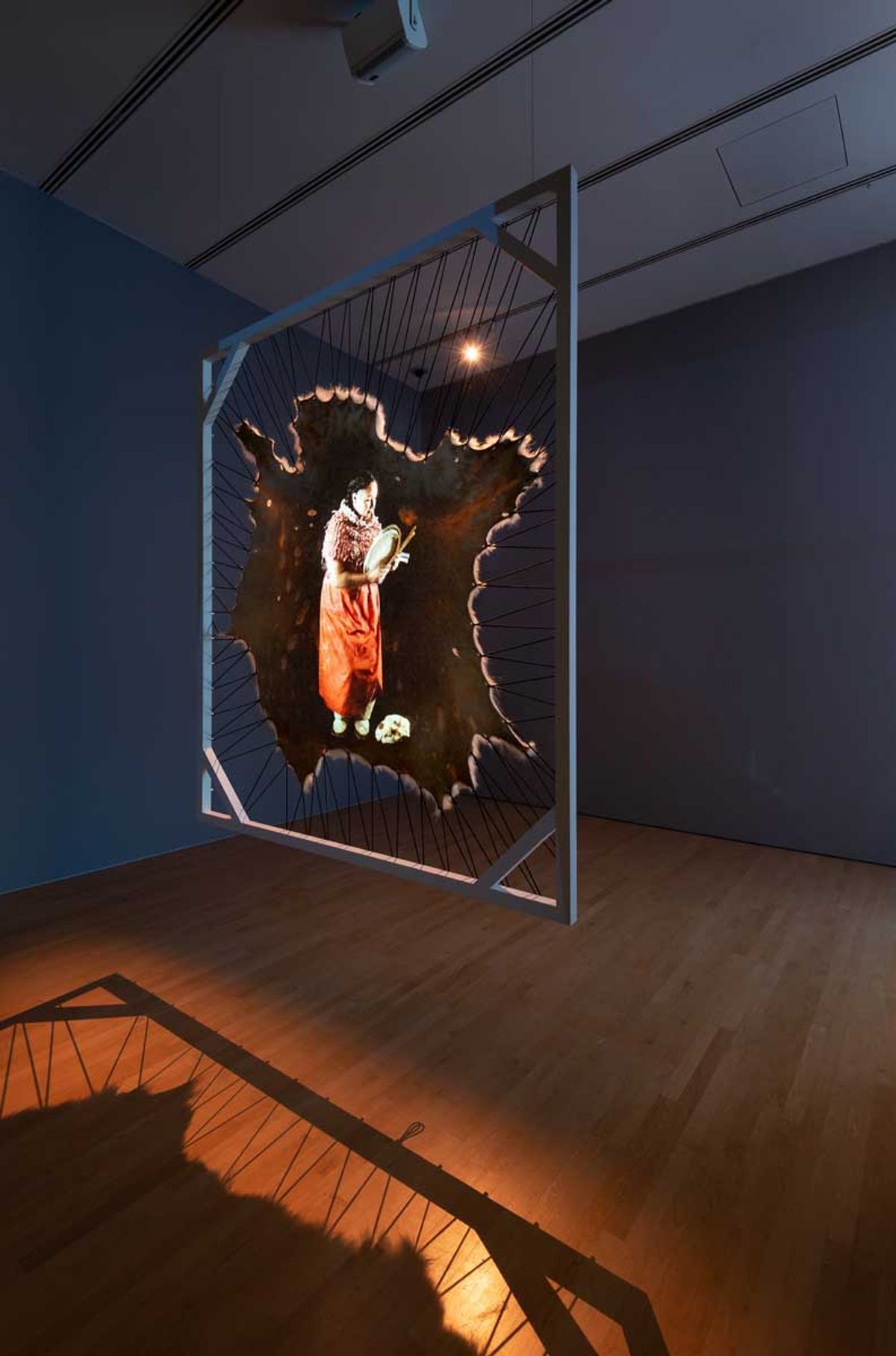 Laakkuluk Williamson Bathory, Nannuppugut! (2021), polar bear skin, wooden frame, elasticated rope and projected video. Collection of the artist. Photo courtesy the National Gallery of Canada. © Laakkuluk Williamson Bathory