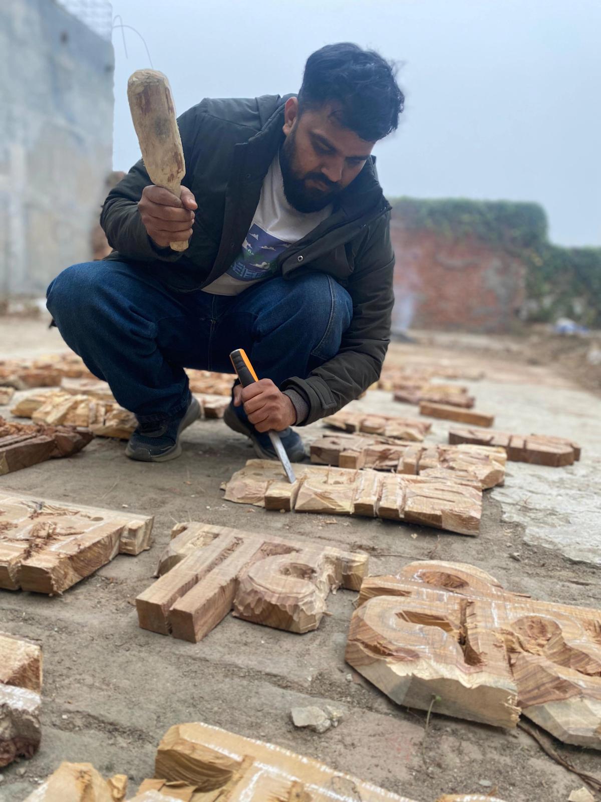 Bihar-based artist-in-resident Umesh S. carves a poetic verse onto panels of waste wood Courtesy of the artist