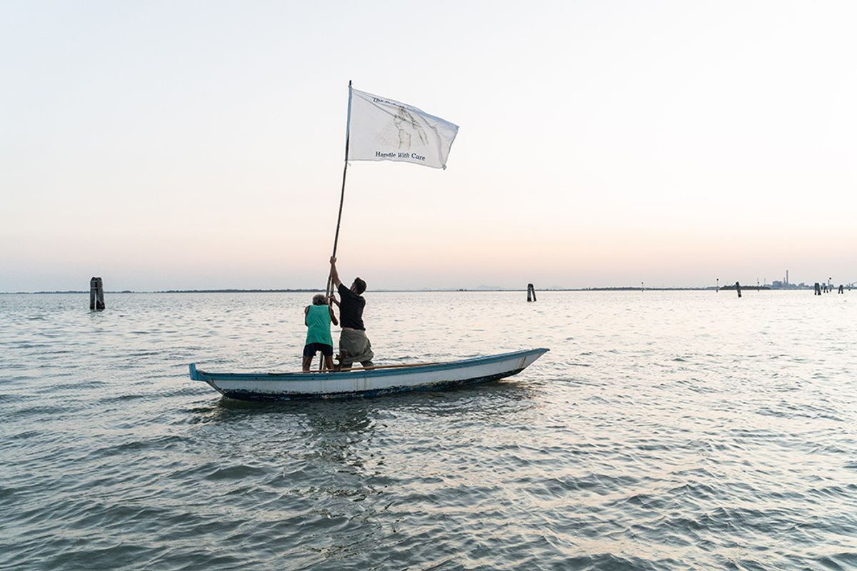 Denes’s flag with the message The Future is Fragile, Handle with Care in the Venice Lagoon Photo: Culturunners