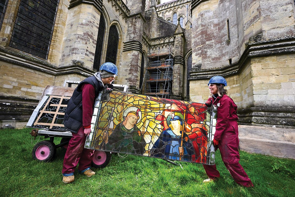 Conservators Vicky Pearce (left) and Kate Kersey (right) with a section of Angeli Ministrantes; Burne-Jones’s window consists of two lancets, each featuring a pair of angels Finnbarr Webster