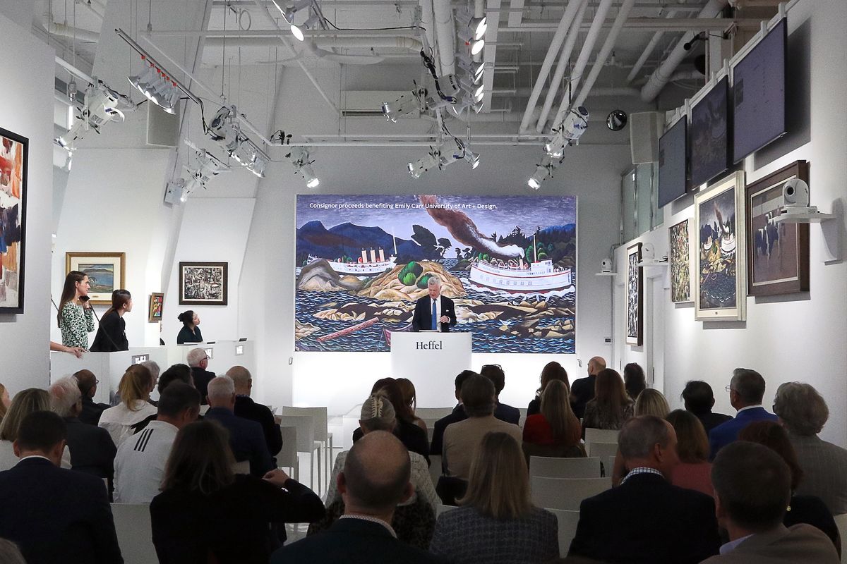 Heffel vice president Robert Heffel fields bids for E.J. Hughes's Coastal Boats Near Sidney, BC during Thursday's auction Courtesy Heffel