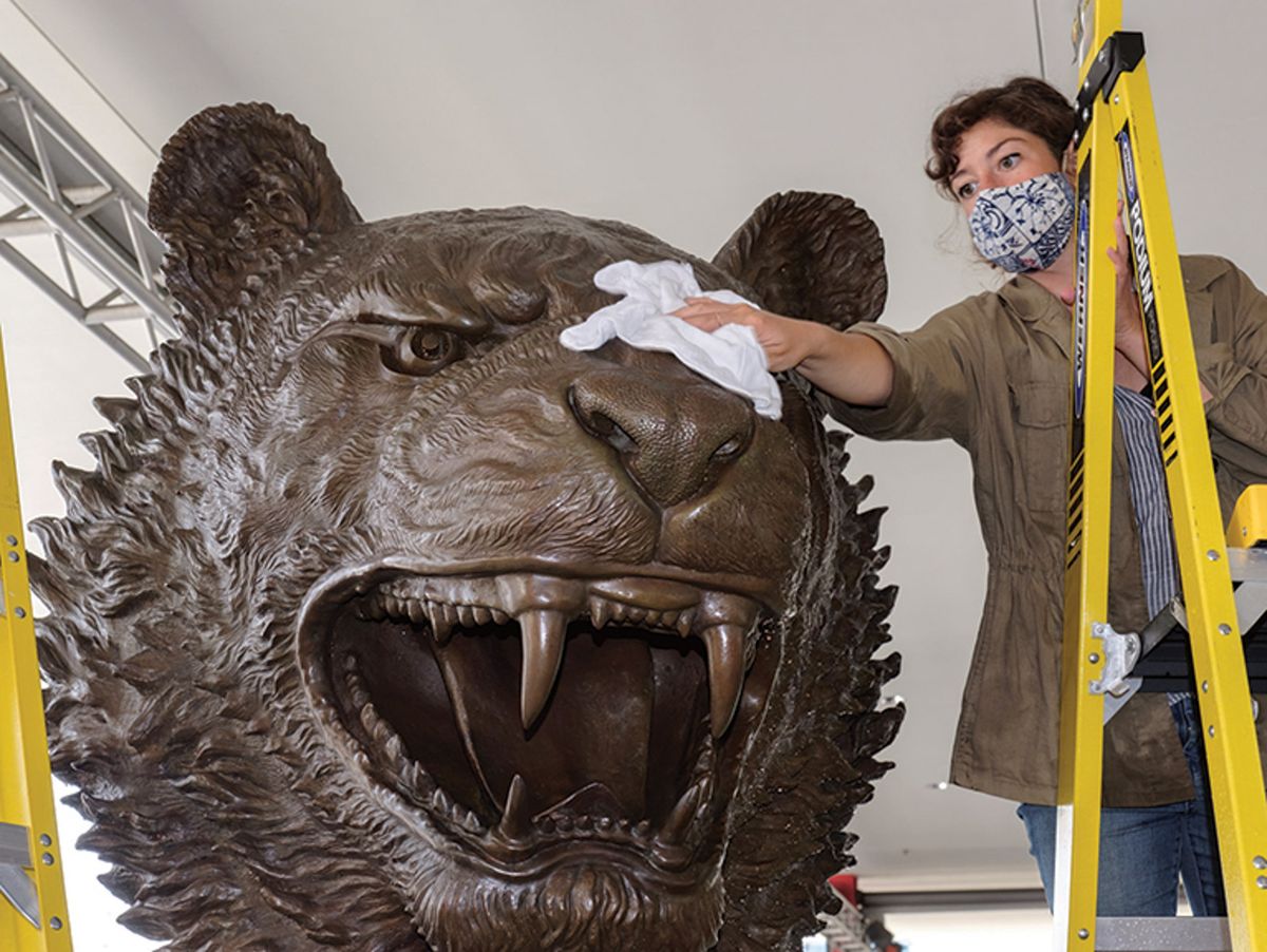 A conservator at Lacma buffing an Ai Weiwei sculpture after an application of heated wax Photo: Yosi Pozeilov; © Lacma Conservation Center