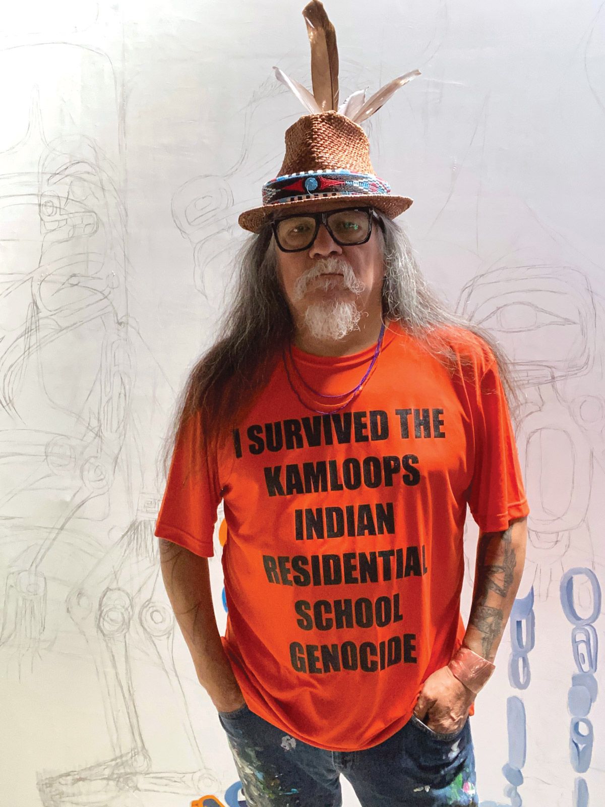 Lawrence Paul Yuxweluptun, a Cowichan/Syilx artist based in Vancouver, in front of his painting Spirit Child Walking Home Courtesy of Macaulay & Co. Fine Art and the artist