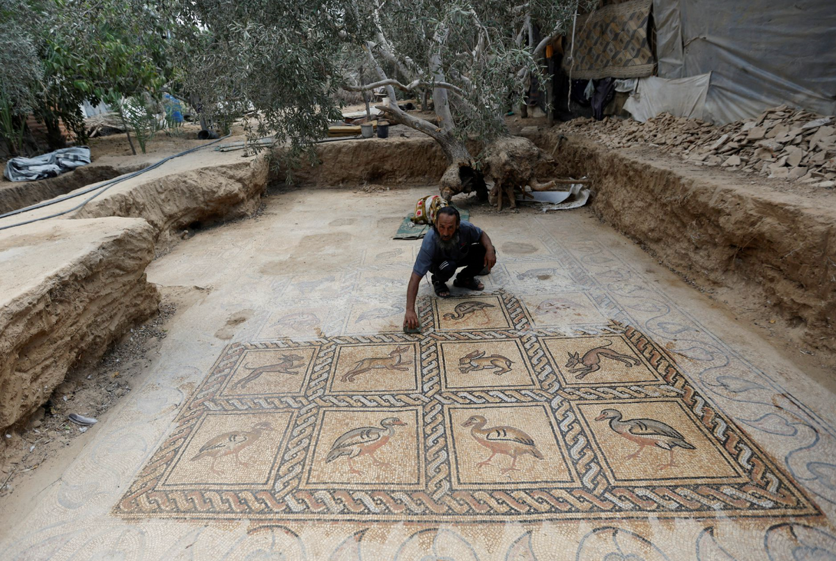 Salman al-Nabahin with the mosaic floor he uncovered in Bureij 
Photo: Reuters