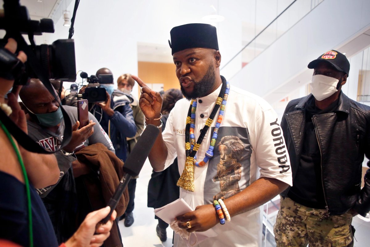 The Congolese activist Emery Mwazulu Diyabanza speaks to the media at the Palais de Justice courthouse, in Paris, where he and others are on trial on aggravated theft charges for trying to remove a 19th century African funeral pole from a Paris museum, in a protest against colonial-era plundering of African art © AP Photo/Thibault Camus