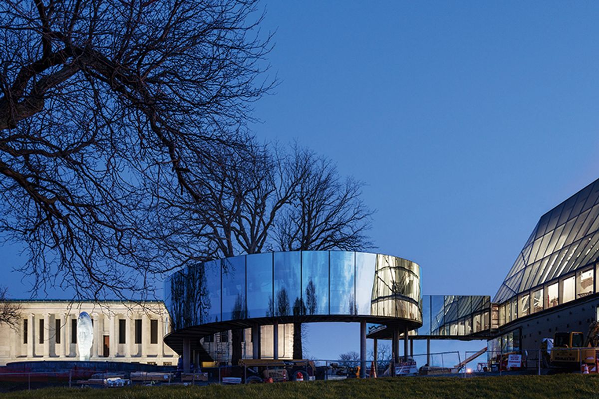 A curved, glass-walled bridge connects new and old buildings at the expanded Buffalo AKG Art Museum © Marco Cappelletti