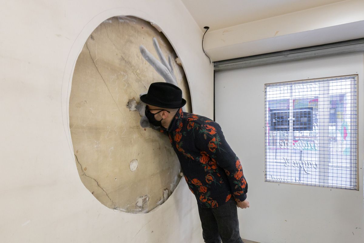 JR inspects a work in his exhibition “Truc a faire” at Galleria Continua Paris Photo: © Sara De Santis. Courtesy of the artists and Galleria Continua