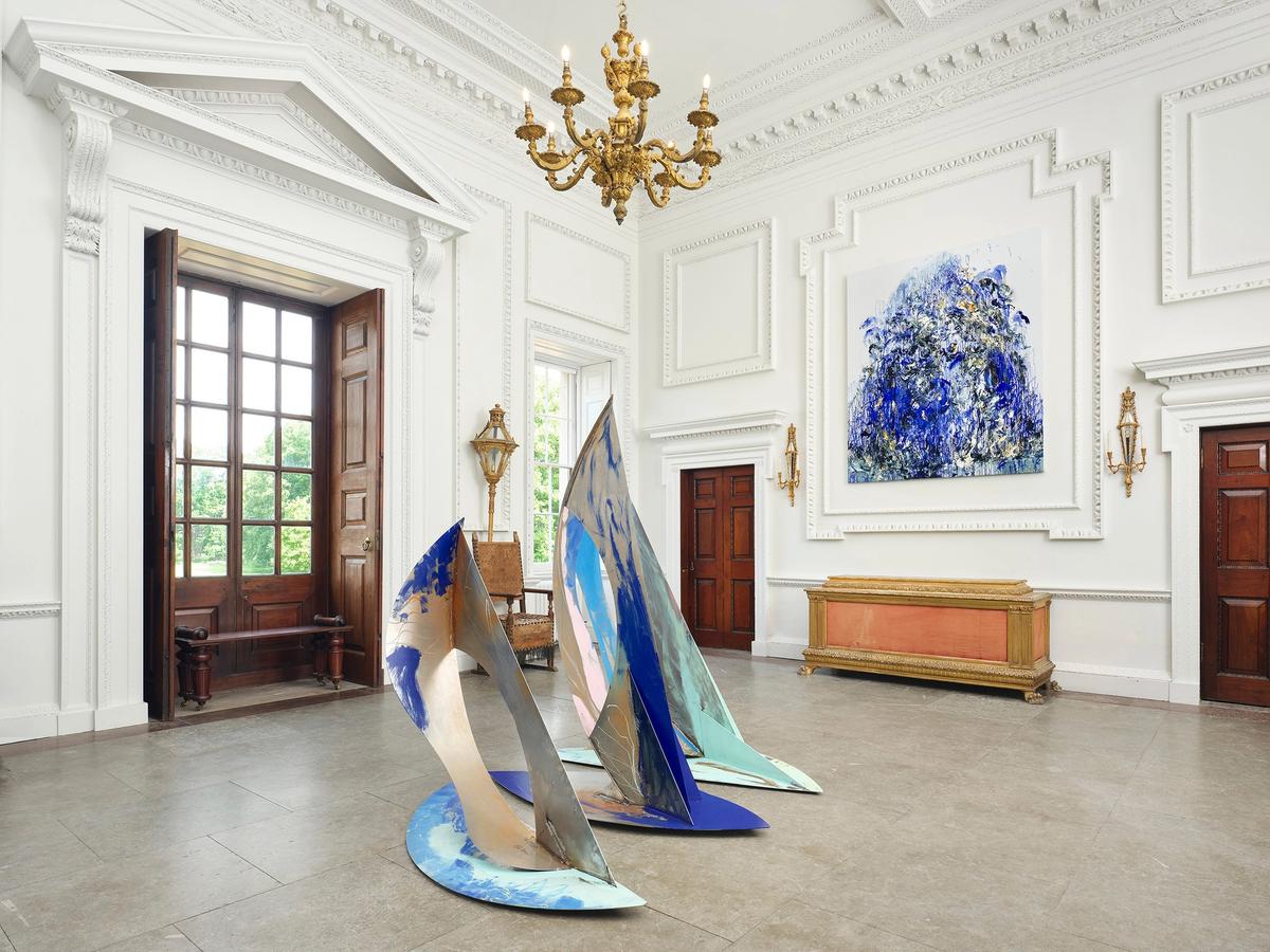 Ro Robertson's The Swell (centre) and Maggi Hambling's Wall of Water XXVII (2025), on show at Wolterton Hall, Norfolk, as part of the exhibition Sea State. Robertson's welded steel sculpture is due to be moved to the grounds of Wolterton early in 2026 Photo: Eva Herzog. Courtesy the artists and Wolterton