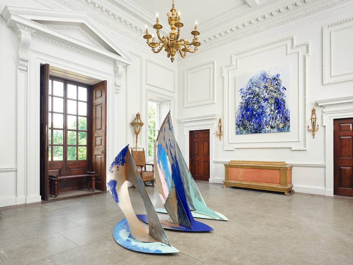 Ro Robertson's The Swell (centre) and Maggi Hambling's Wall of Water XXVII (2025), on show at Wolterton Hall, Norfolk, as part of the exhibition Sea State. Robertson's welded steel sculpture is due to be moved to the grounds of Wolterton early in 2026 Photo: Eva Herzog. Courtesy the artists and Wolterton