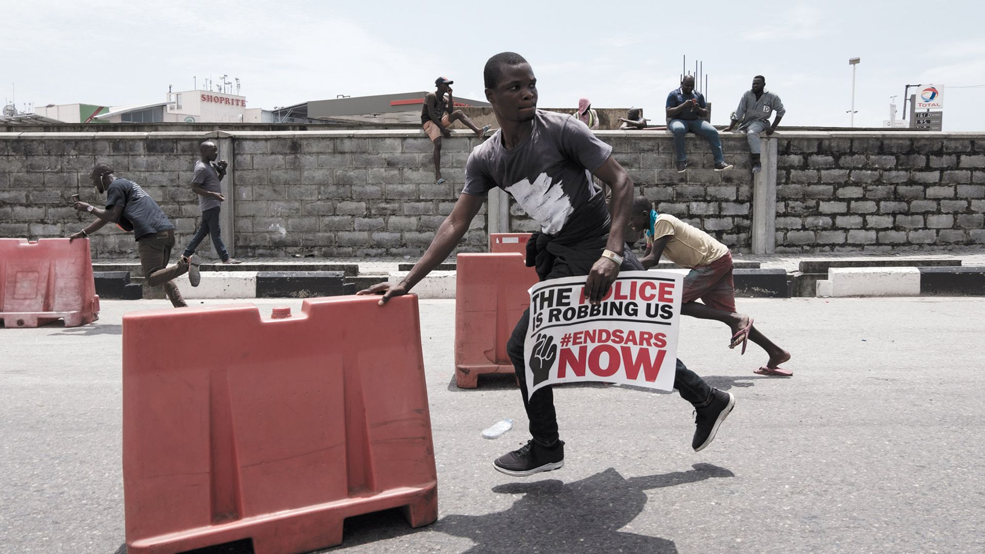Artist Ifebusola Shotunde’s photograph of a protester running is one of the 100 #EndSARS documentary works that will be shown at Art X Lagos in December © Art X Lagos
