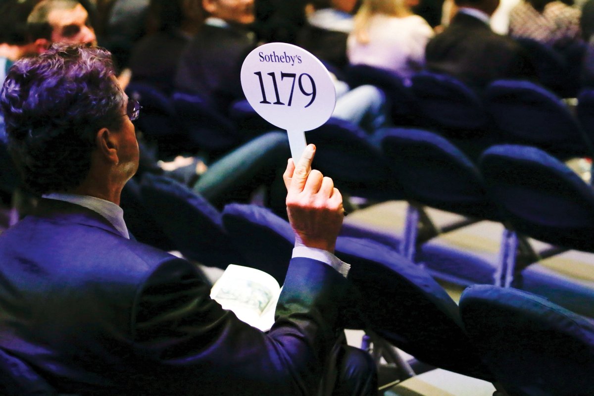 A bidder at Sotheby’s in New York; auction houses say they were not consulted on, or given notice of, the rule changes
Kena Betancur/Getty Images