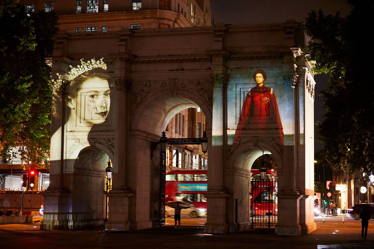 Annigoni's 1970 portrait of Queen Elizabeth II (right) is projected on to Marble Arch, London, in 2022, as part of the Platinum Jubilee celebrations. To the left is Dorothy Wilding's 1952 photograph of the Queen Annigoni: © Pietro Annigoni, All rights reserved. DACS 2022. Photograph: © Michael Pilkington/National Portrait Gallery