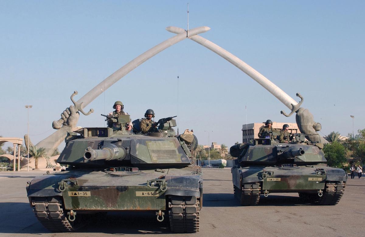 US Army tanks and soldiers stop under the "Hands of Victory" in Ceremony Square, Baghdad, during Operation Iraqi Freedom, 13 November 2003 Photo: Technical Sergeant John L. Houghton, Jr, United States Air Force