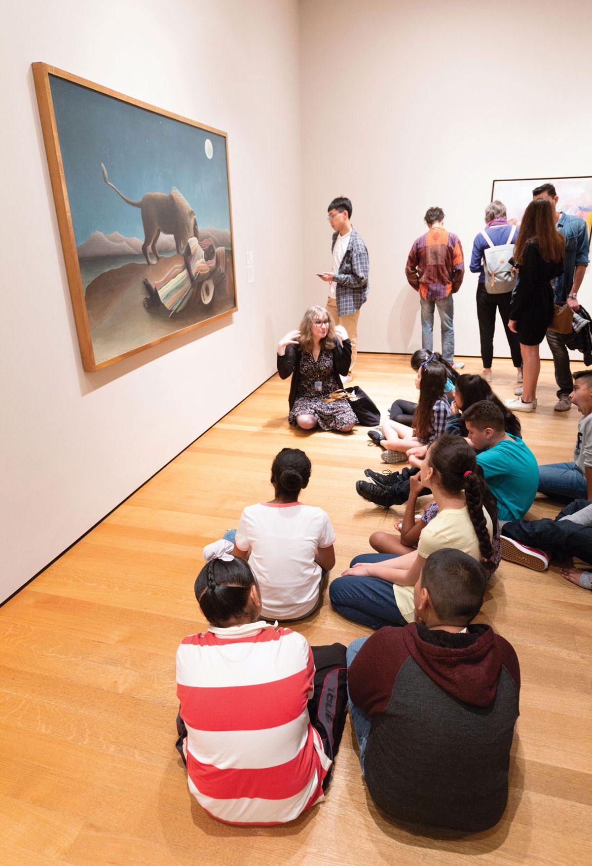 A school group learns about Henri Rousseau’s The Sleeping Gypsy at New York’s Museum of Modern Art Alamy
