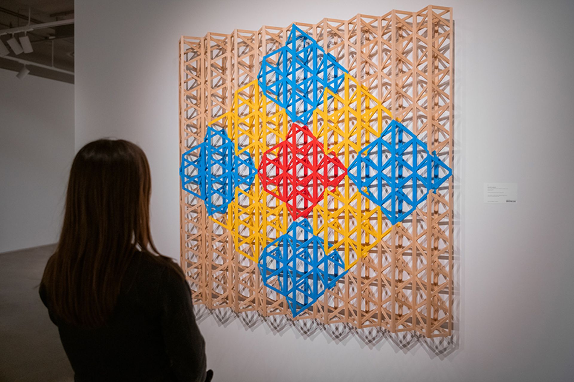 Installation view of the selling exhibition Crafting Geometry: Abstract Art from South and West Asia at Sotheby's New York. Shown here: Rasheed Araeen's Red Square Breaking into Primary Colors © Julian Cassady Photography LTD