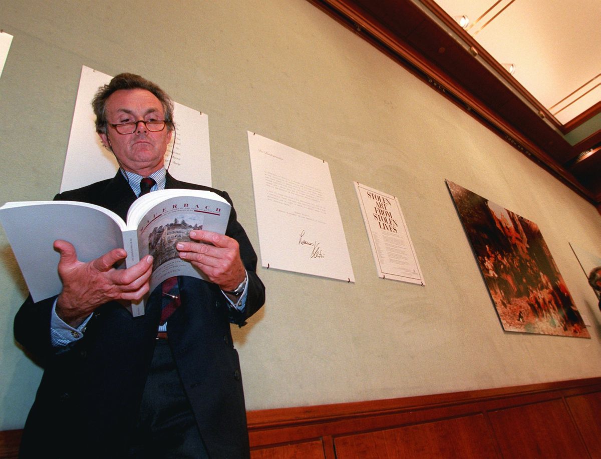Lord Hindlip, chairman of Christie's International, browses through a Mauerbach Benefit catalogue at a news conference at Christie s Auction House in New York . The auction of about 8,000 pieces of art confiscated by the Nazis during World War II and hidden in various locations across Europe, held in Vienna, provided restitution for Holocaust victims and their families Photo: Anders Krusberg/AP/Shutterstock