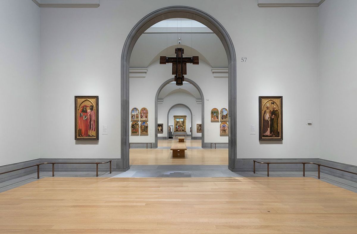 Antonio and Piero del Pollaiuolo’s newly restored The Martyrdom of St Sebastian, is seen at the far end of the central, nave-like, enfilade of the Sainsbury Wing galleries. With Segna di Bonaventura’s Crucifix (foreground) suspended from the ceiling Photograph: The National Gallery