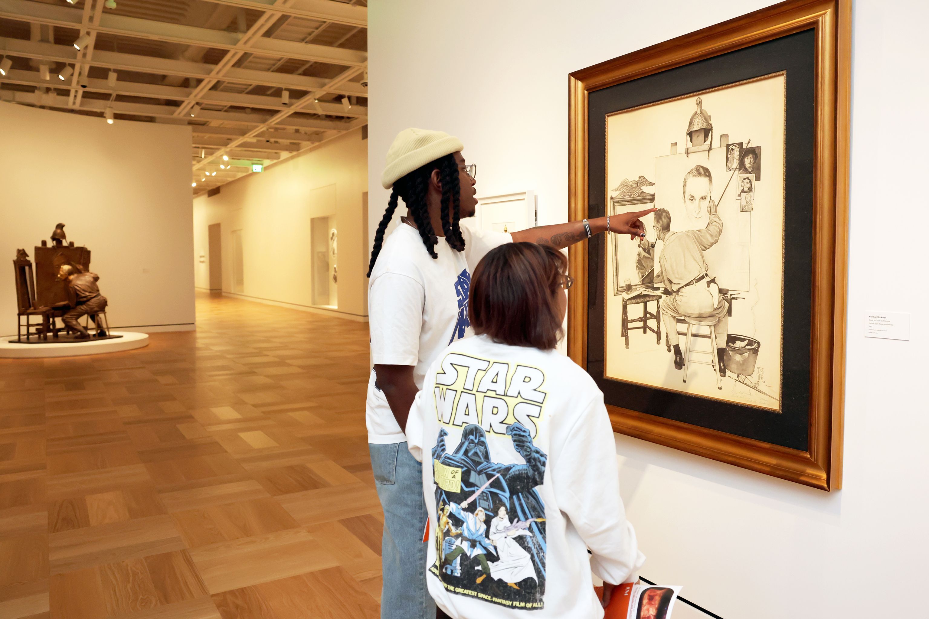 The museum has a gallery devoted to Norman Rockwell, which includes a newly commissioned bronze (at left) of the artist’s witty 1960 Triple Self-Portrait Photo: Stefanie Keenan/Getty Images for Lucas Museum of Narrative Art