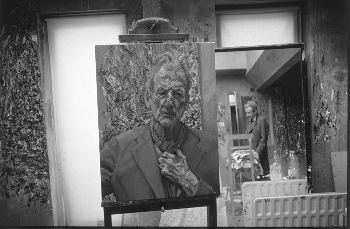 Lucian Freud's painting Self-portrait, Reflection (2002) with the artist reflected in a mirror in the background © William Feaver