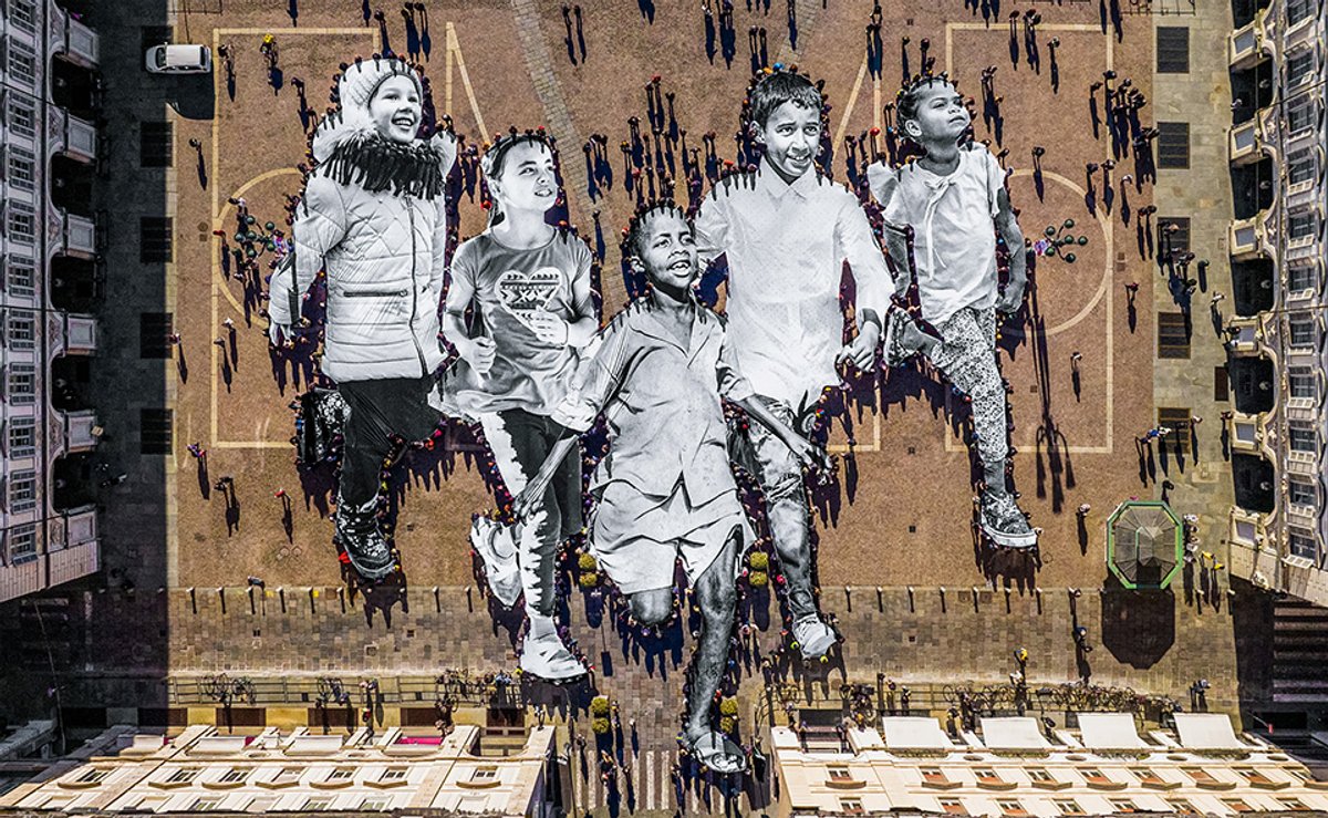 This image of JR's Déplacé.e.s (2023) procession in Turin is featured in a new book about the street artist JR and © Atelier JR