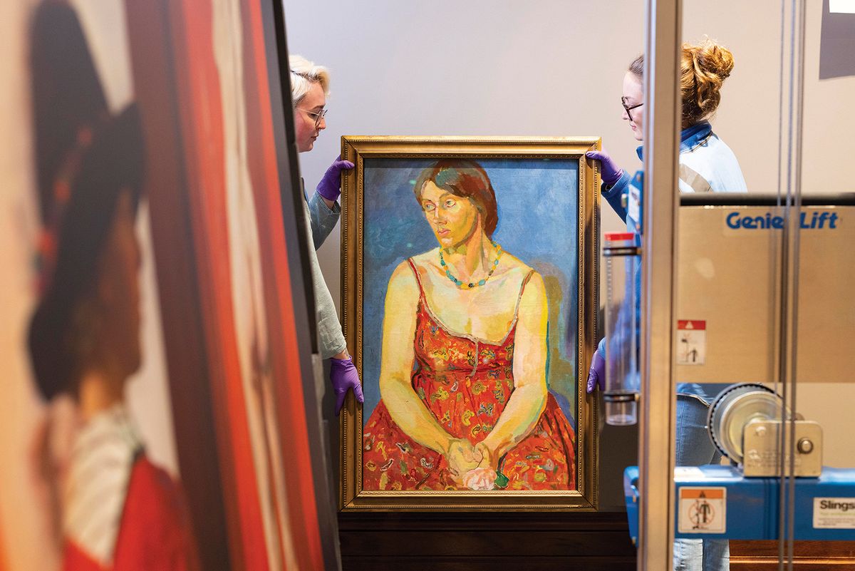 Staff at the gallery carry a portrait of Vanessa Bell by Duncan Grant (around 1918) during the rehang; the gallery is increasing its proportion of portraits of women from 37% to nearly half Photo: David Parry