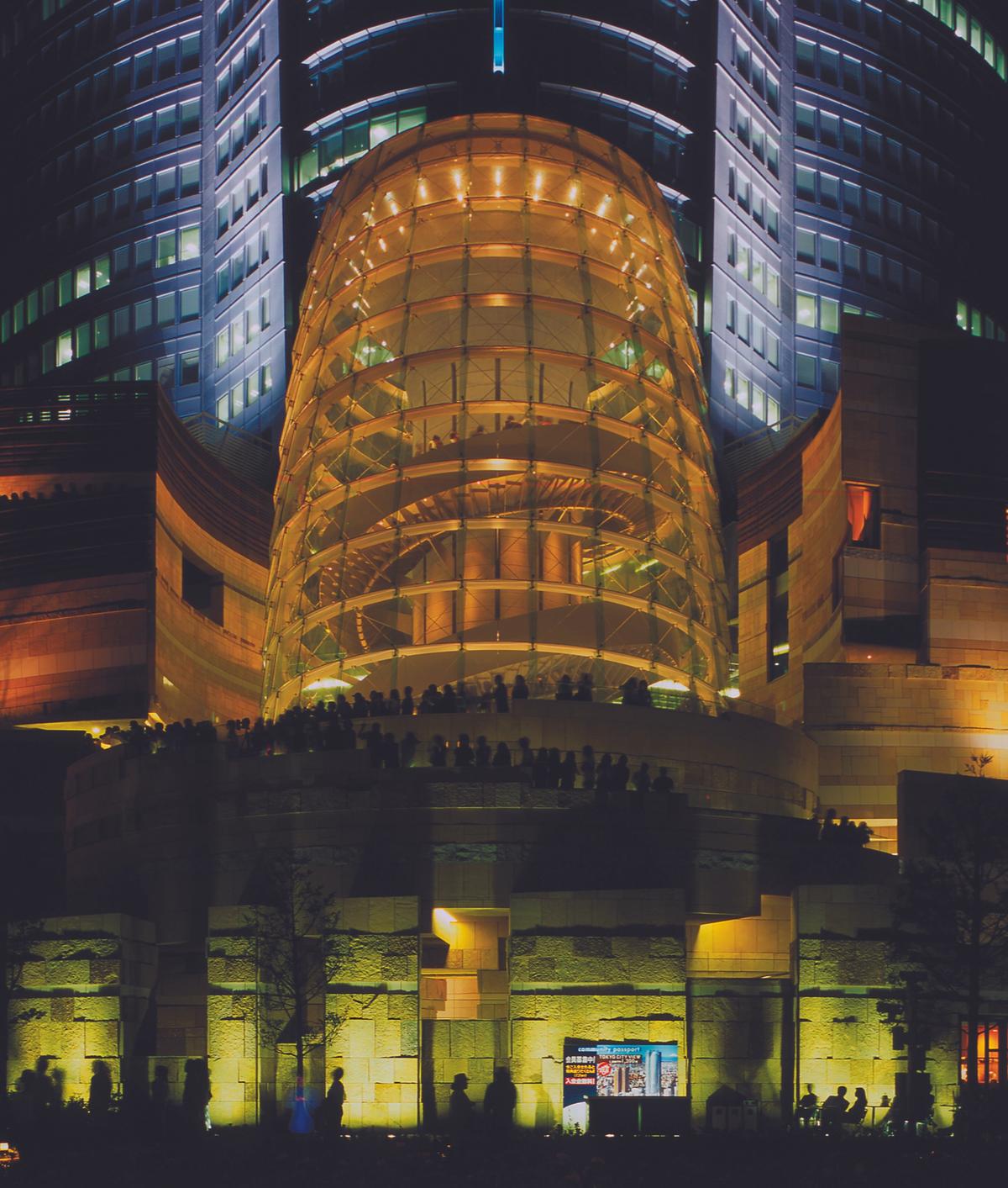 The “cone” that marks the entrance to the Mori Art Museum in Tokyo becomes a luminous beacon at night. The museum itself is on the 53rd floor of the skyscraper Image: Courtesy of Mori Art Museum