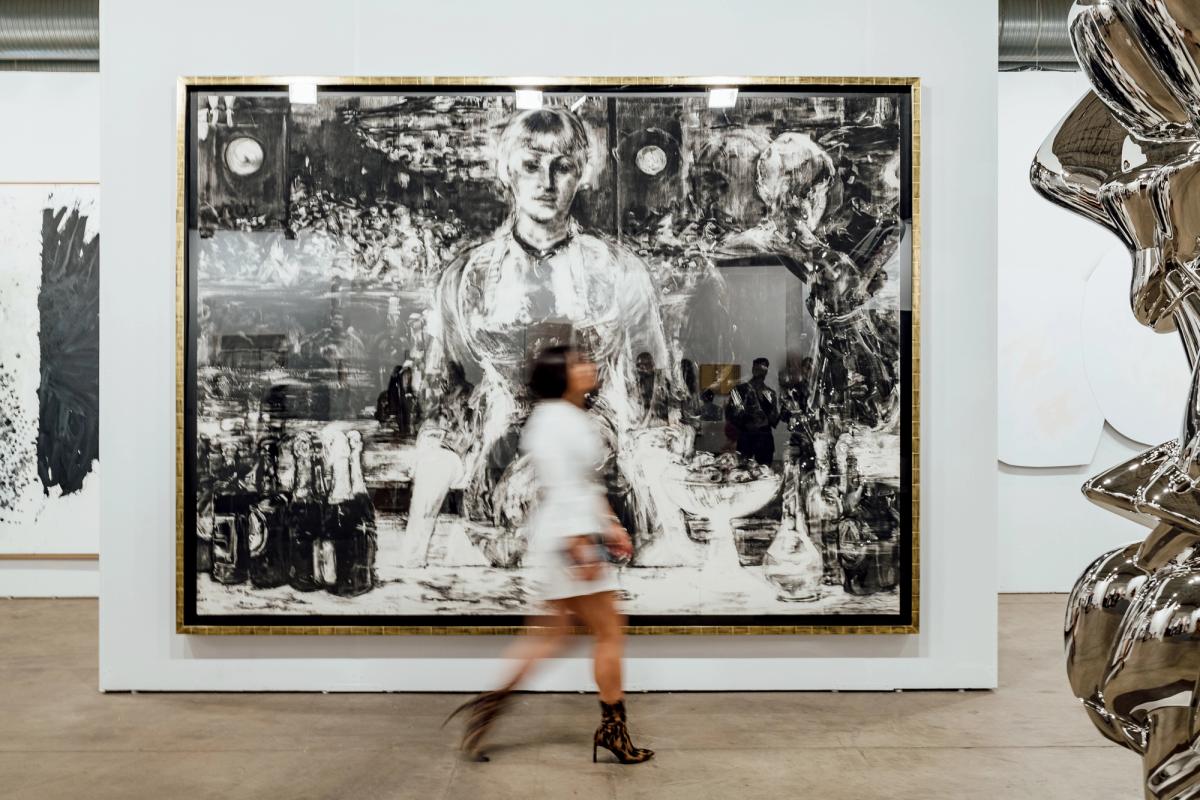 A fair-goer walks by first-time Expo exhibitor Galerie Thaddeus Ropac's booth. Photo by Kevin Serna, Courtesy of Galerie Thaddaeus Ropac (London, Paris, Salzburg) and Expo Chicago.