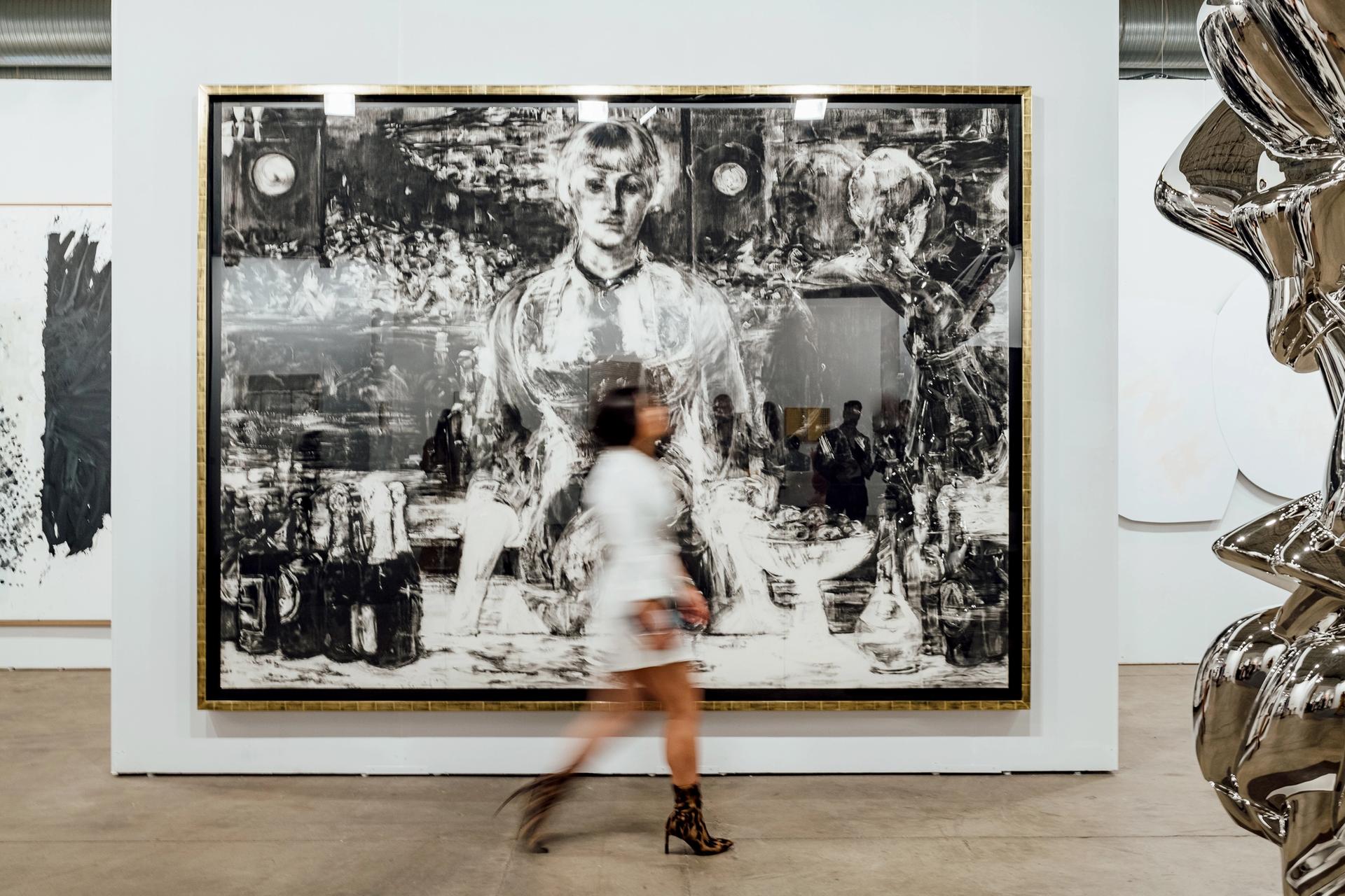 A fair-goer walks by first-time Expo exhibitor Galerie Thaddeus Ropac's booth. Photo by Kevin Serna, Courtesy of Galerie Thaddaeus Ropac (London, Paris, Salzburg) and Expo Chicago.