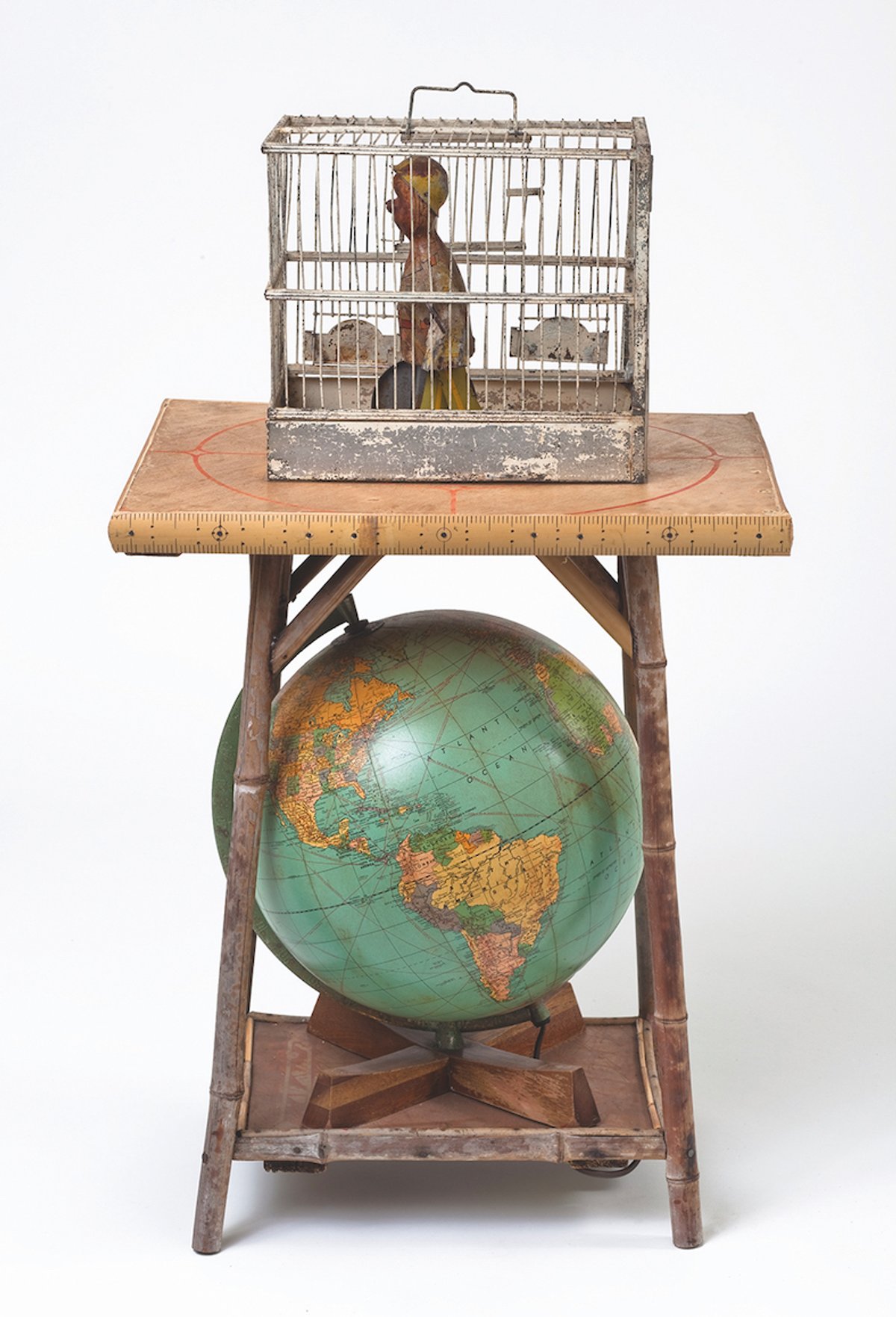 Betye Saar’s assemblage Globe Trotter (2007), with a doll in a birdcage above a globe in reference to the slave trade
Courtesy of Betye Saar and Roberts Projects, Los Angeles. Photo: Brian Forrest