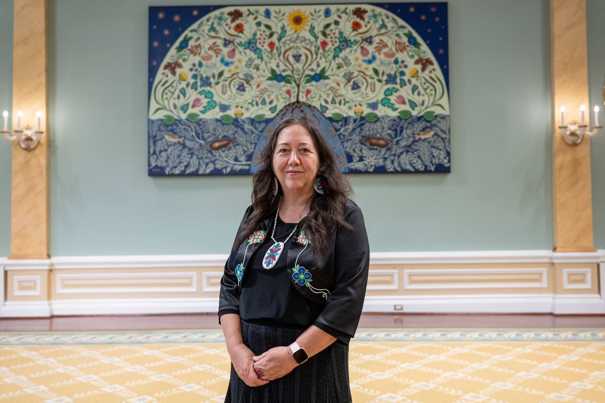 Artist Christi Belcourt with her painting Honouring My Spirit Helpers (2010) on view in Rideau Hall, the governor general's residence in Ottawa © Office of the Secretary to the Governor General, via Facebook