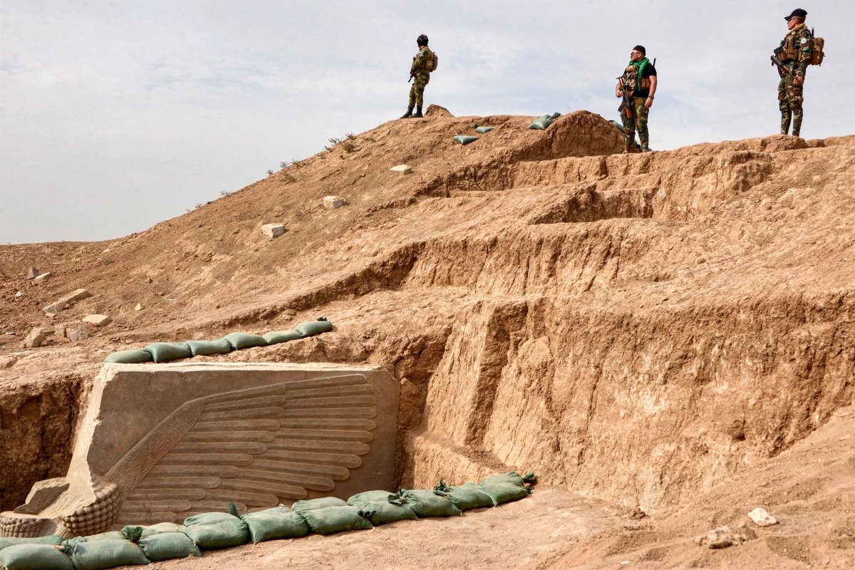 Iraqi security forces stand guard at the site where the lamassu was re-excavated by a joint Iraqi-French team
Photo: Zaid Al-Obeidi/AFP via Getty Images