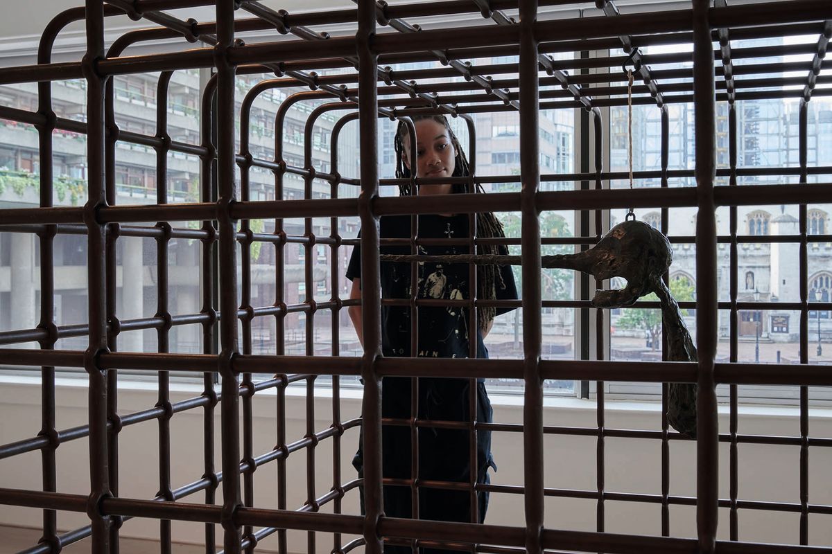 Alberto Giacometti’s sculpture Le Nez (1947) is contained within Mona Hatoum’s steel Cube (2006) in a new show at the Barbican Jo Underhill, Barbican Art Gallery