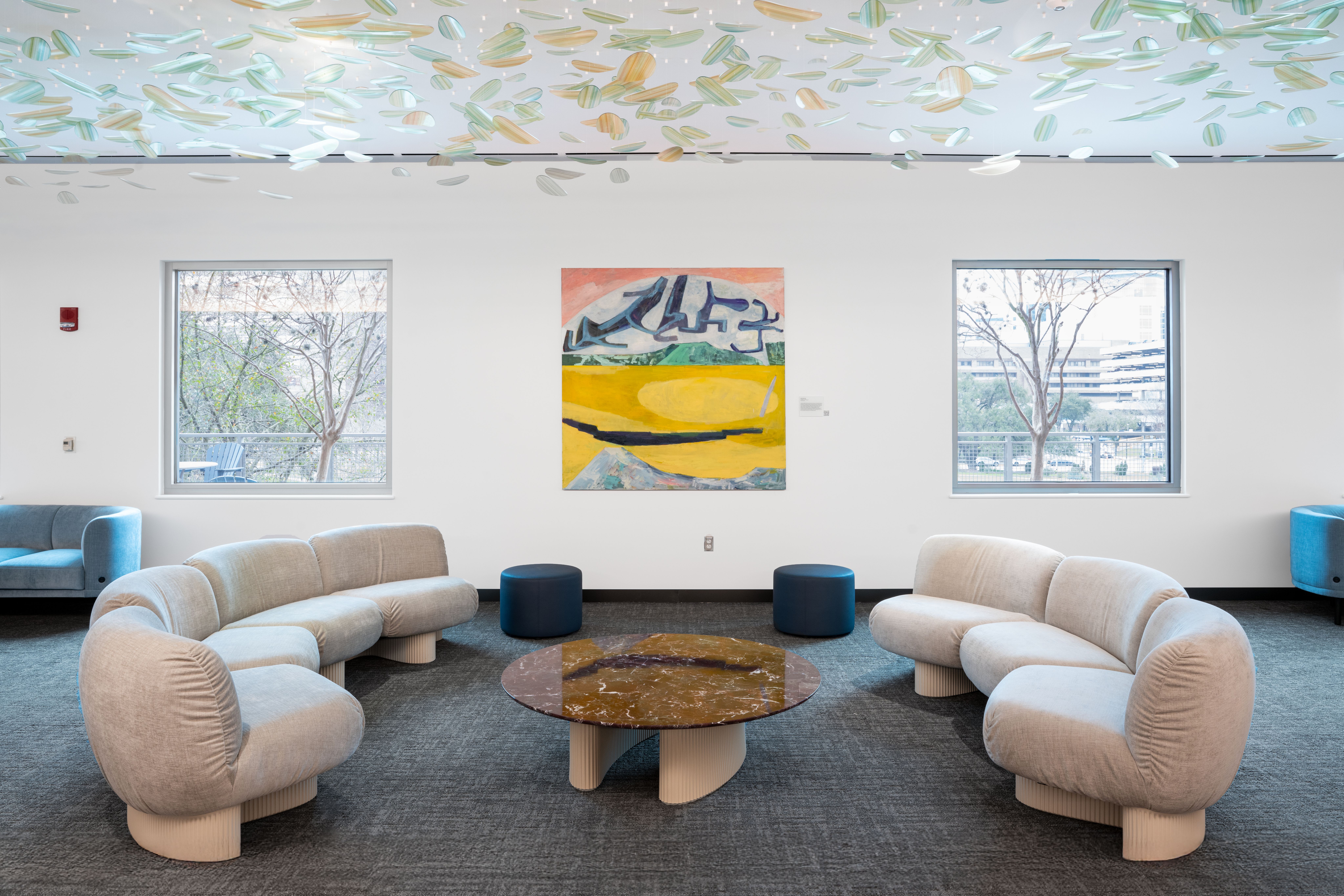 A view of the waiting room in MD Anderson's Colorectal Cancer Center, with David Aylsworth's painting Fraughter Than I Thought (2023) and the installation Carried by the Breeze by Shane Allbritton Courtesy MD Anderson