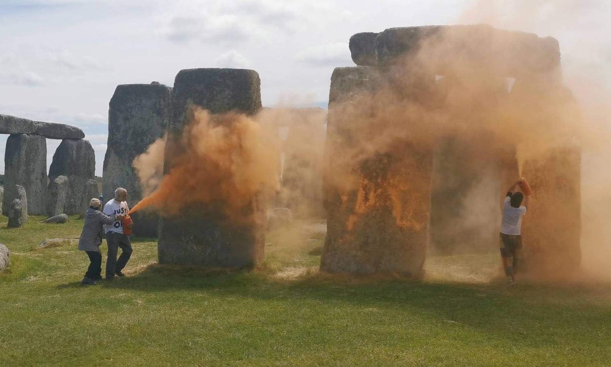Two eco-activists arrested after Stonehenge sprayed with orange powder Two eco-activists arrested after Stonehenge sprayed with orange powder