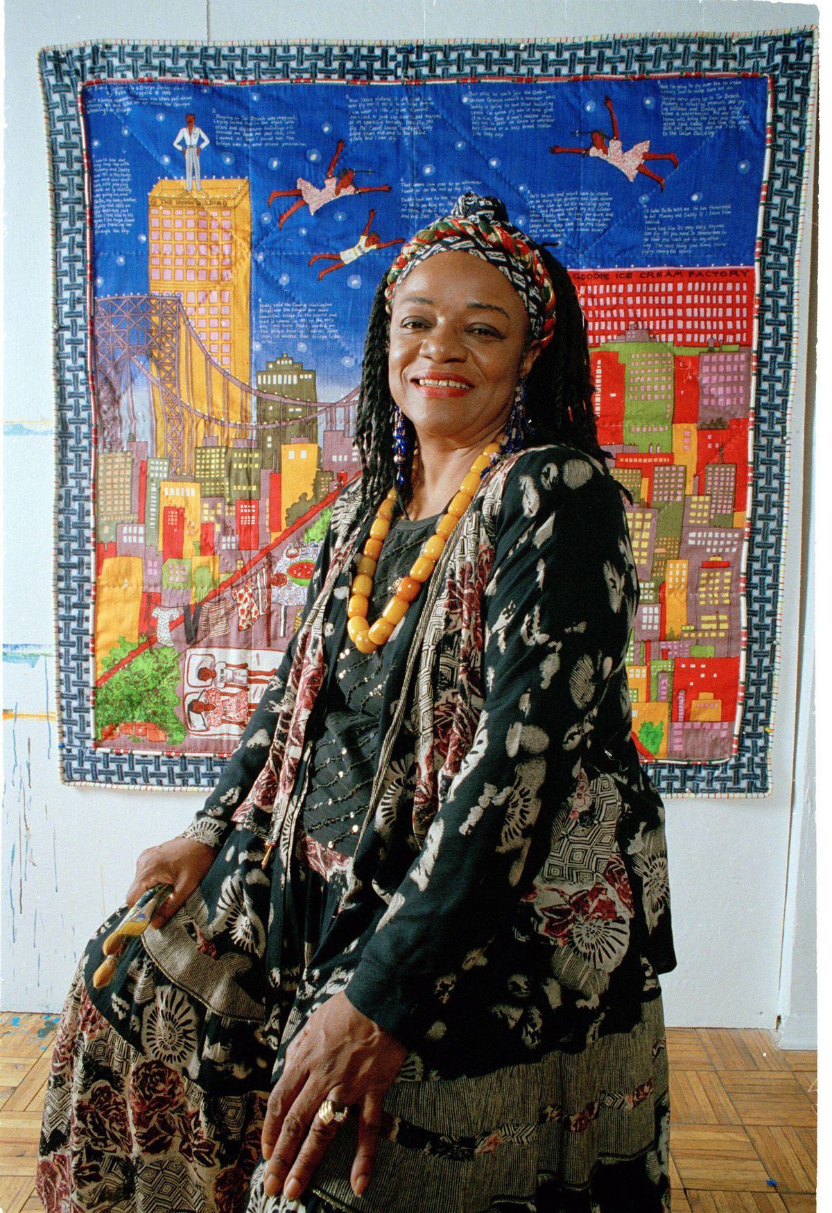 Faith Ringgold with a quilt from her Woman on a Bridge series in her New York City studio, July 1993. Photograph: AP Photo/Kathy Willens. Artwork: © 2024 Faith Ringgold/Artists Rights Society (ARS), New York and DACS, London. Courtesy ACA Galleries 