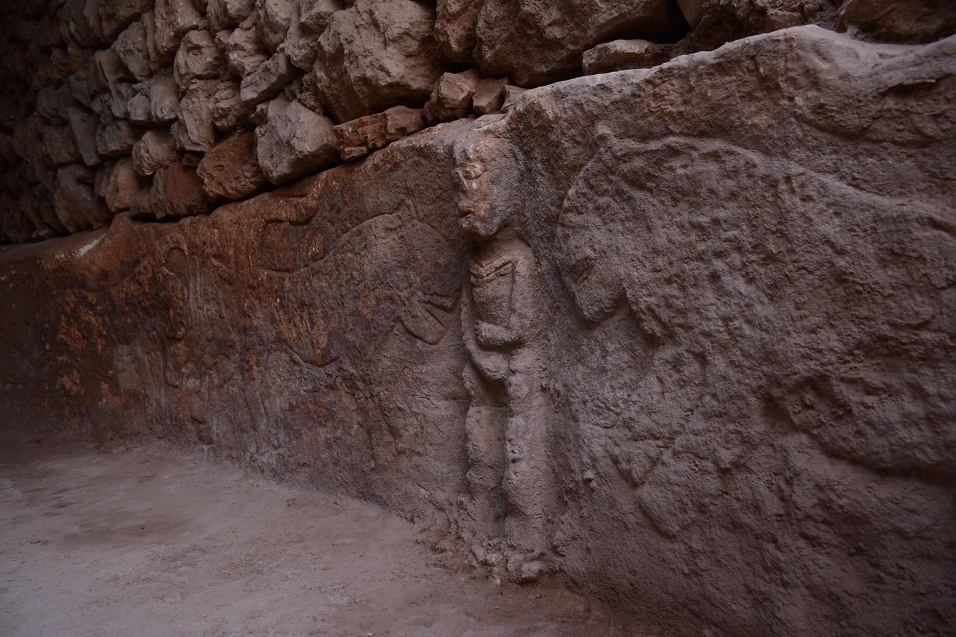 The carving of a man holding his penis surrounded by leopards is the oldest known depiction of a narrative scene, archaeologists say