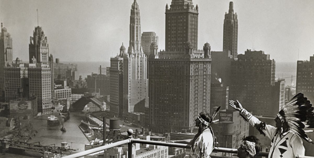 Princess O-Me-Me, a Chippewa, Sun Road, a Pueblo, and Chief Whirling Thunder, a Winnebago, look over Chicago's skyline from the roof of the Hotel Sherman  03 October, 1929 Photo: Underwood & Underwood/CORBIS/Corbis via Getty Images