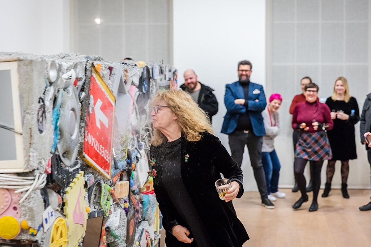 Jane Crawford adds the finishing touches to the latest Garbage Wall Courtesy of Louisa Buck