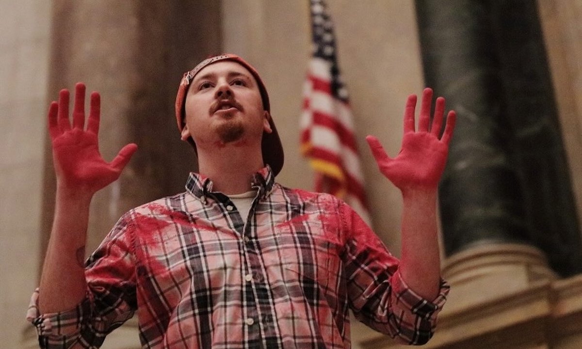 Two climate activists charged for pouring red powder on National Archives display of the US Constitution Two climate activists charged for pouring red powder on National Archives display of the US Constitution