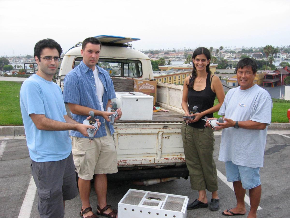 Feathered forecasters: from left to right, Cina Hazegh, Kevin Ponto, Beatriz da Costa and Bob Matsuyama hold four pigeons wearing air pollution monitor backpacks as part of PigeonBlog (2006-08) Courtesy of the Beatriz da Costa Estate