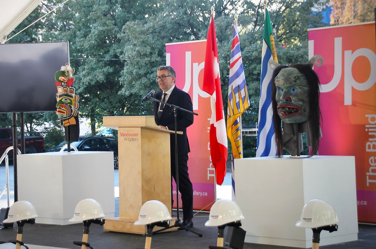 Vancouver Art Gallery chief executive and director Anthony Kiendl addresses attendees at a "ground awakening" ceremony for the museum's new building, flanked by newly acquired works by Beau Dick, the late Kwakwaka'wakw Northwest Coast artist and Chief Hadani Ditmars