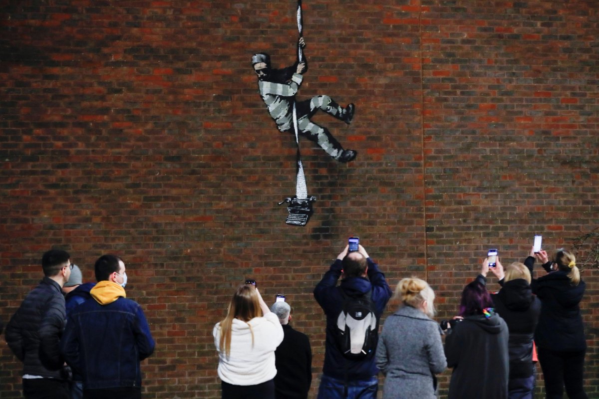 Banksy has painted an image of a prisoner escaping down the walls of Reading Prison using a ream of paper weighted by a typewriter, invoking the institutions most famous inmate—writer Oscar Wilde © REUTERS/Matthew Childs