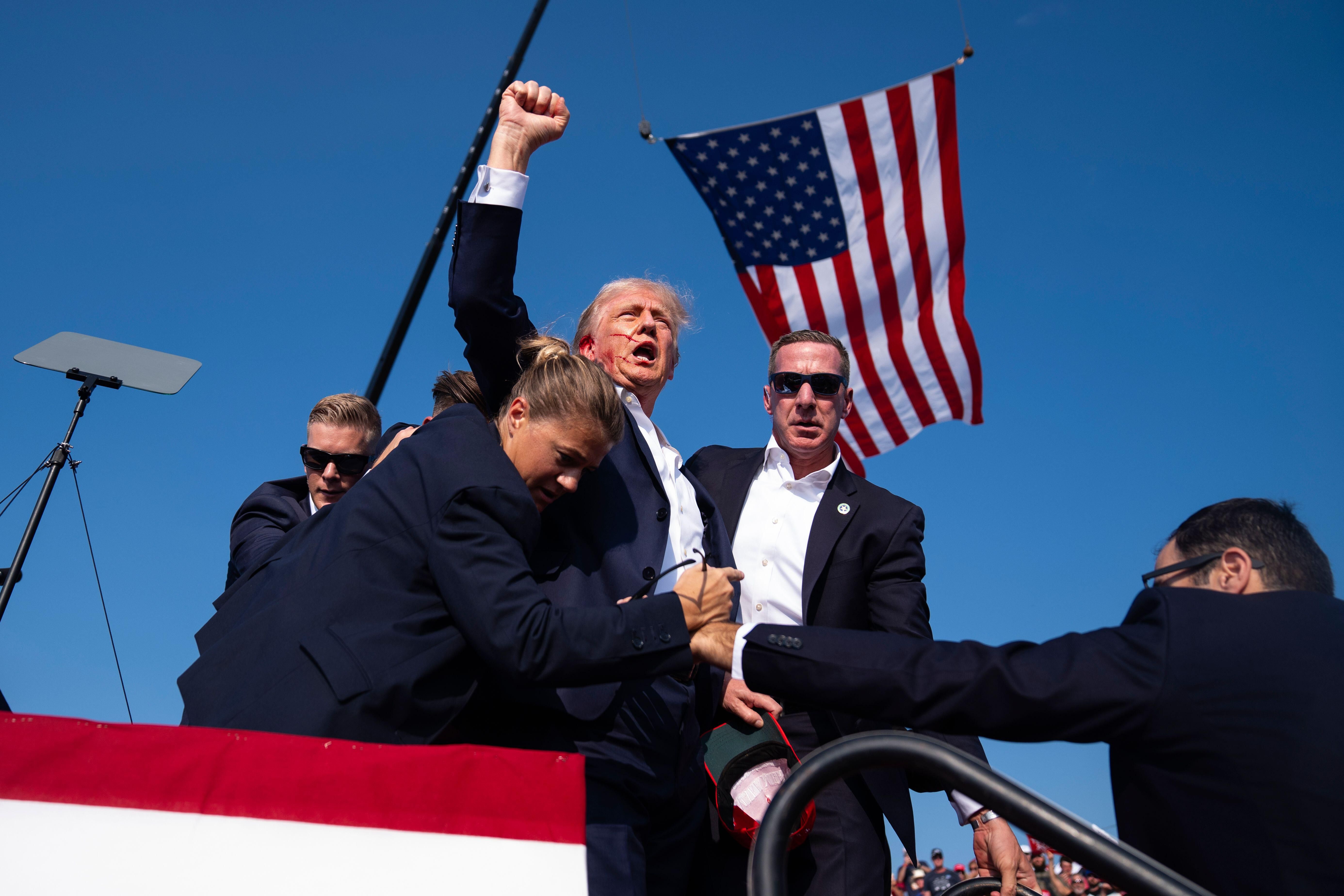 The Republican presidential candidate former President Donald Trump is surrounded by US Secret Service agents at a campaign rally in Pennsylvania

Photo: Associated Press / Alamy Stock Photo