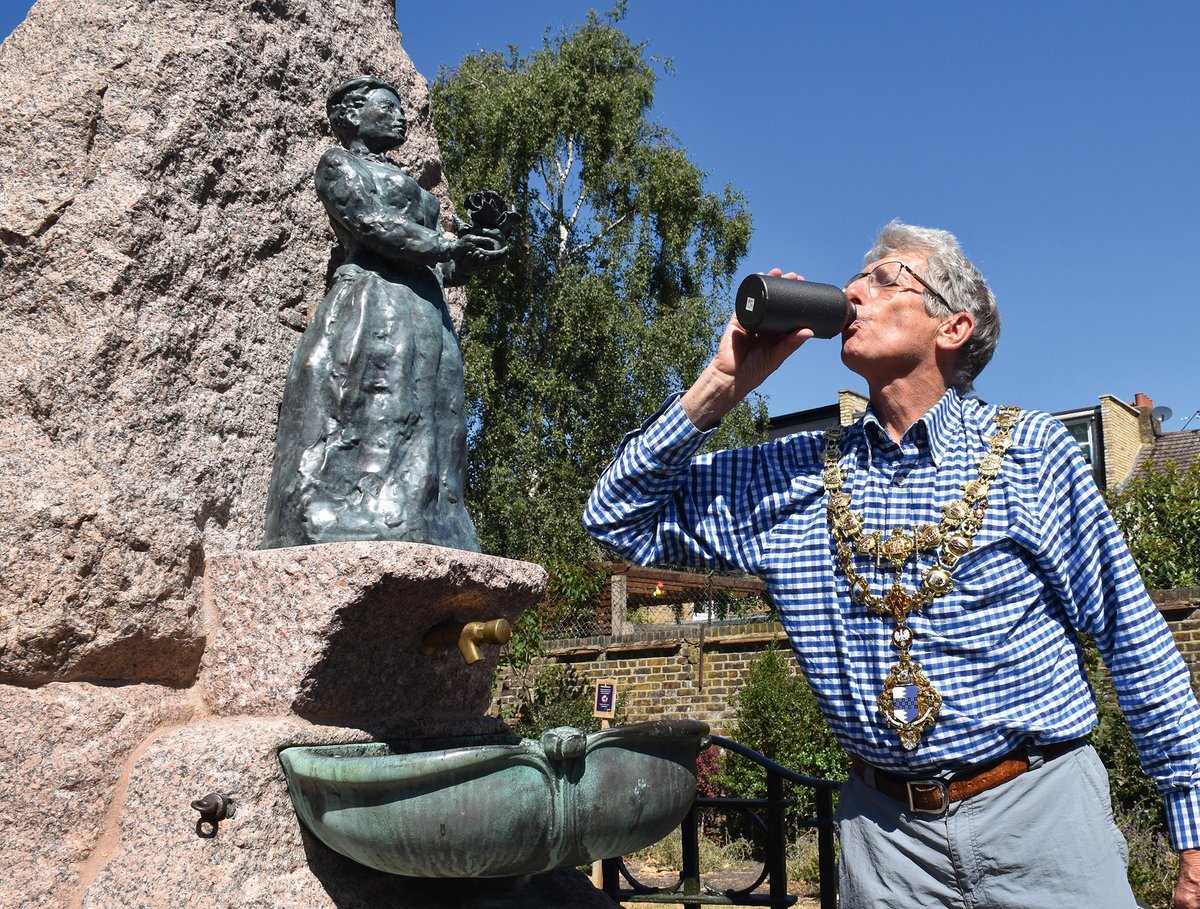 Jeremy Ambache, the mayor of Wandsworth, drinks from the restored fountain below Fanny Wilkinson’s statue
Courtesy Heritage of London Trust