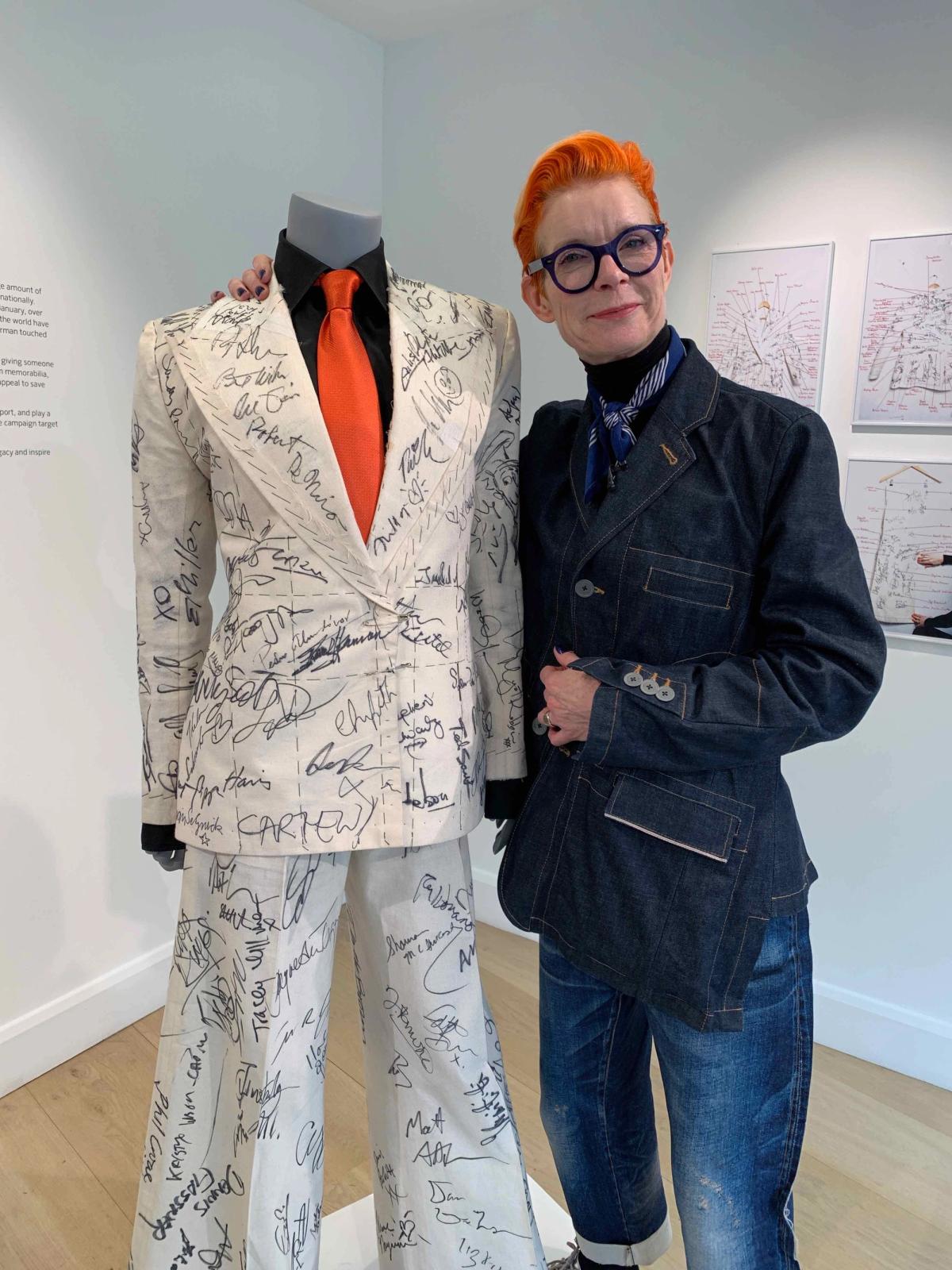 Sandy Powell at Phillips with the suit signed by numerous celebrities courtesy Gareth Harris