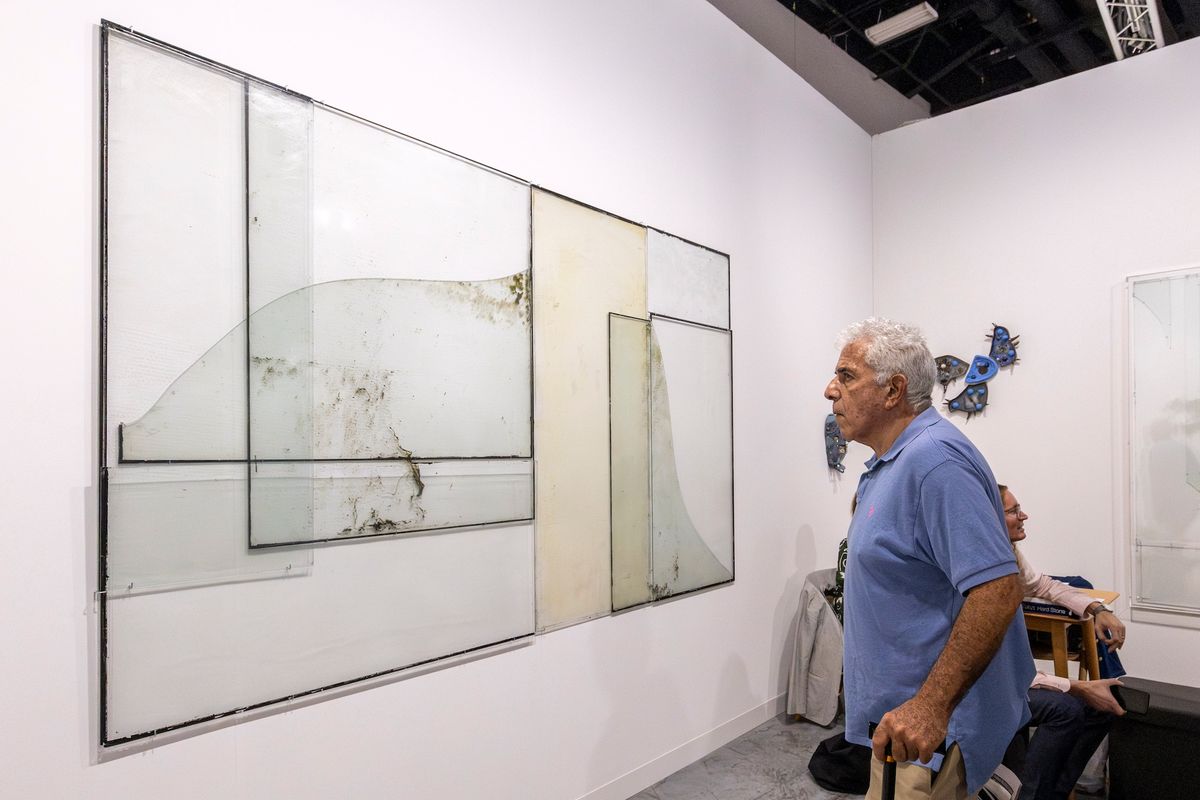 A visitor to Art Basel in Miami Beach looks at Anneke Eussen’s It’s Alright (2023) on Document's stand Liliana Mora